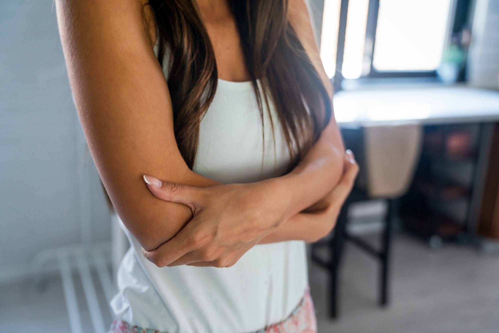 Arm pain and injury concept. Closeup portrait woman with painful elbow